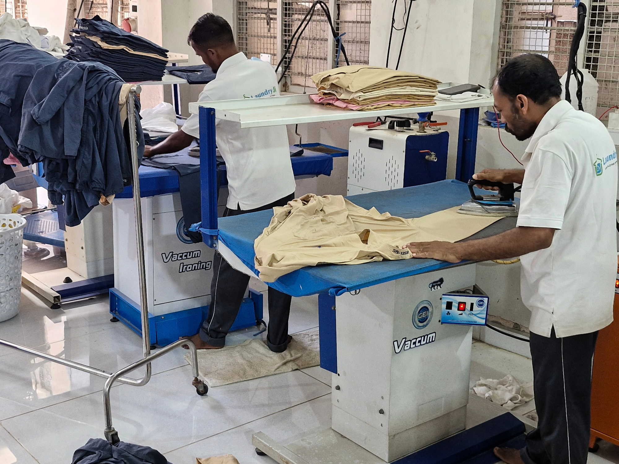 LaundryJi crew performing vacuum ironing and garment finishing